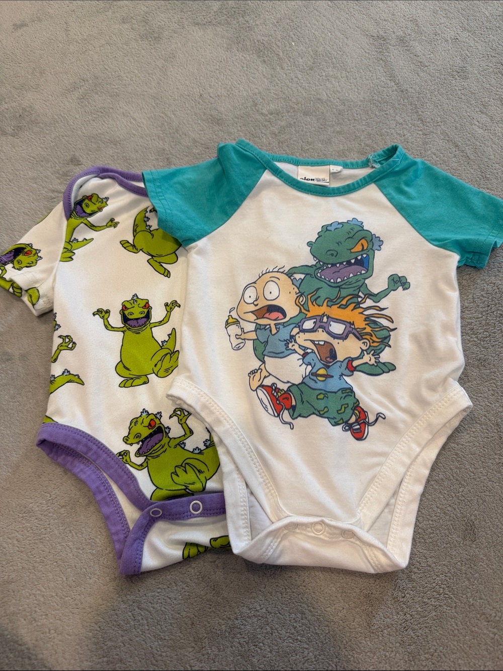 Nickelodeon White Bodysuit with Teal and Purple Cartoon Dino Prints